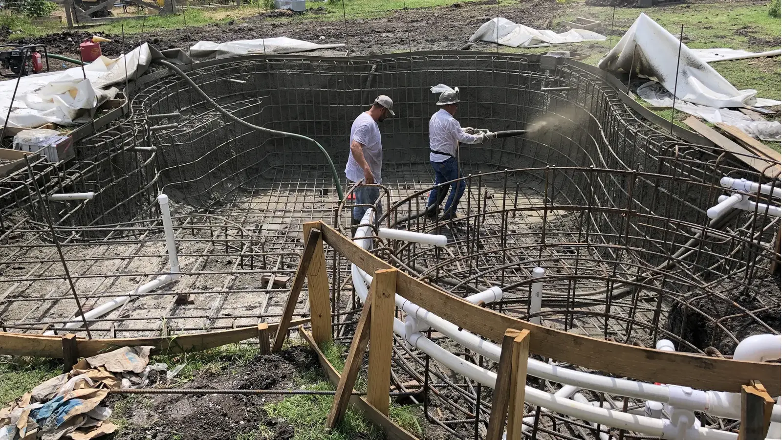 Javier sprays shotcrete onto the walls of the pool.