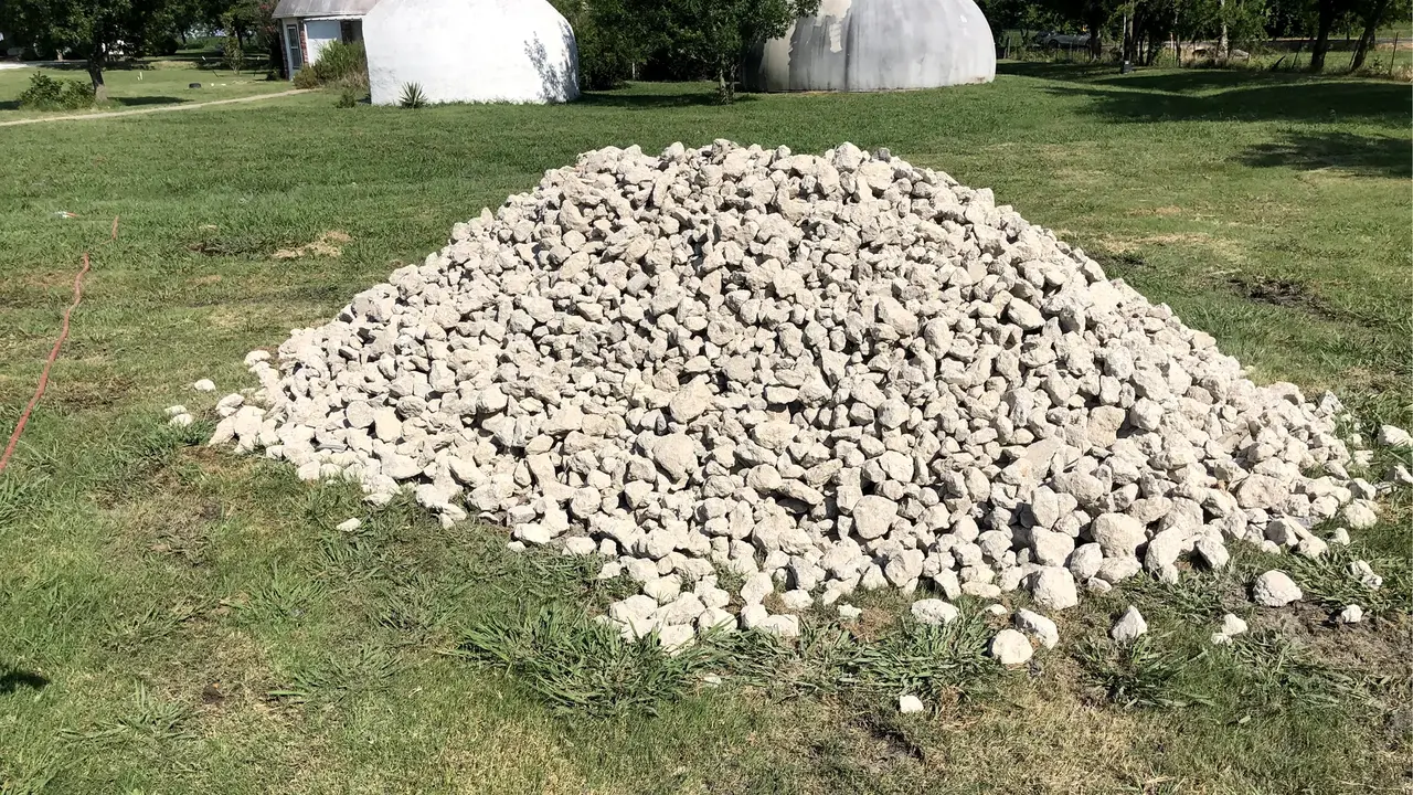 Pile of crushed concrete to fix the muddy mess at the bottom of the hole dug out for the pool.