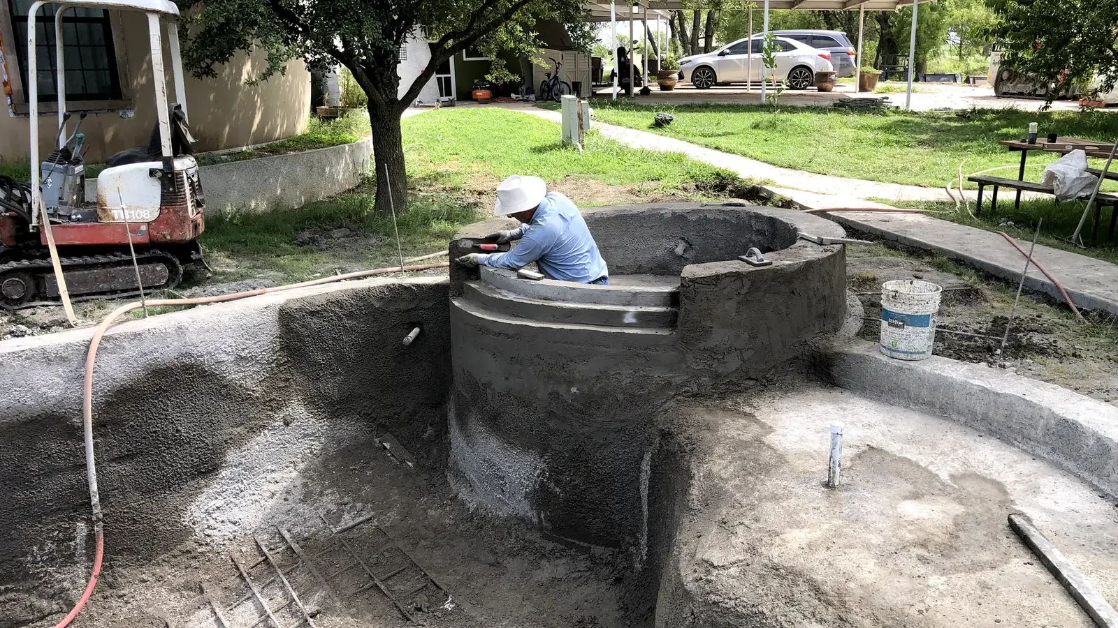 Javier working on leveling the waterfall ledge from the hot tub into the pool.